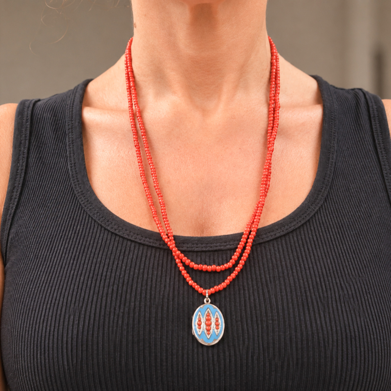 Victorian coral beads with enamel locket for sale in Leeds, shown on model