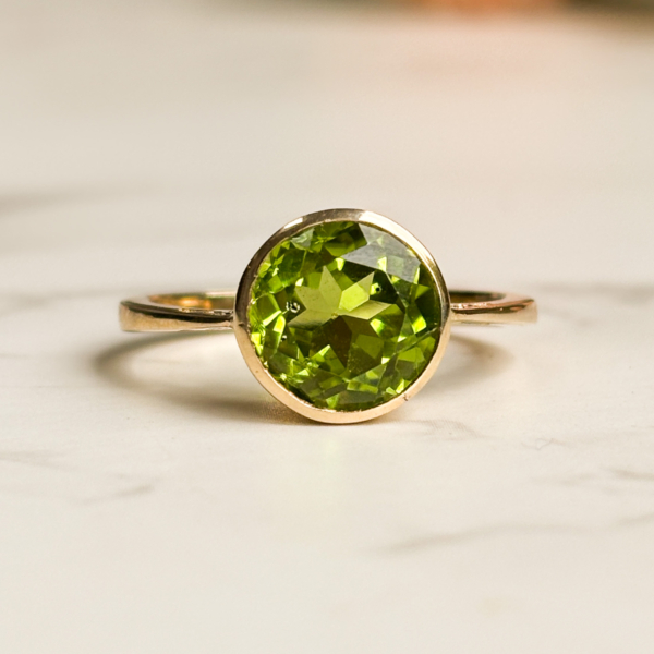 modern 9ct gold peridot ring with bezel setting for sale in Leeds