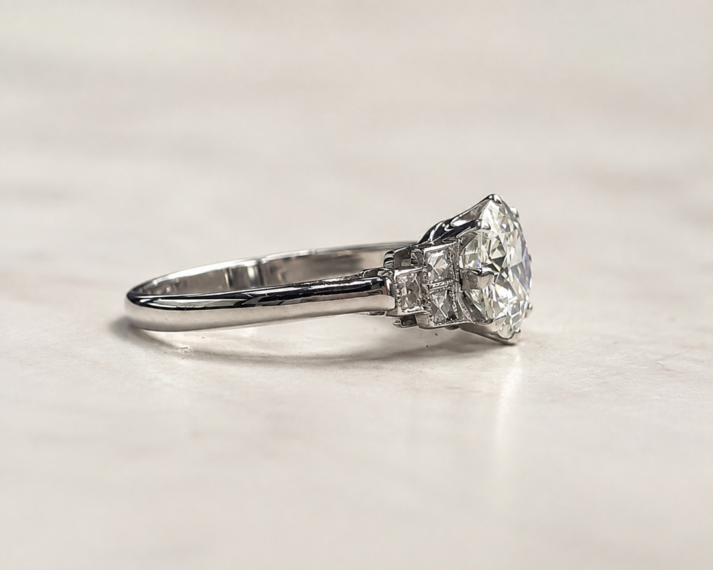 Art Deco 1.5ct diamond solitaire ring VVS1 clarity in platinum. Old cut centre stone and french cut side diamonds. For sale in Leeds, showing the side of the ring