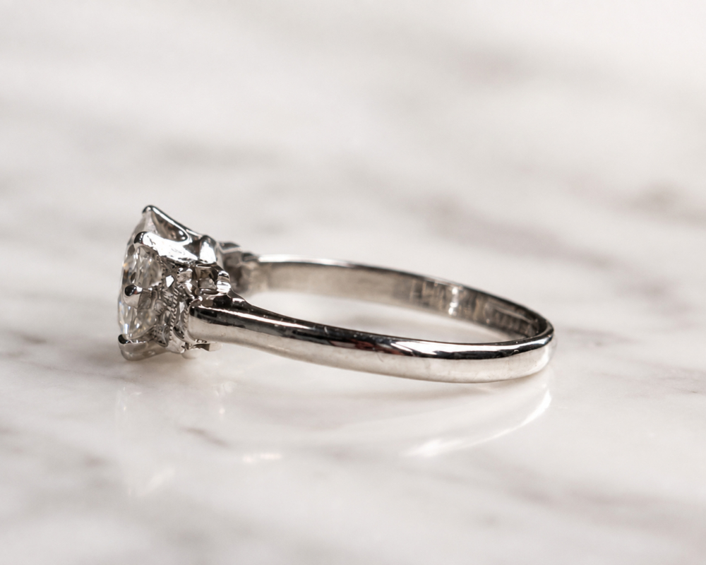 Art Deco 1.5ct diamond solitaire ring VVS1 clarity in platinum. Old cut centre stone and french cut side diamonds. For sale in Leeds, showing the side of the ring