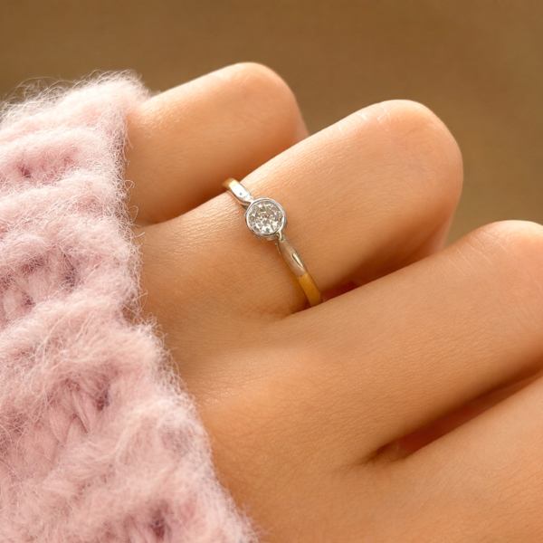 Art Deco diamond solitaire ring in 18ct gold with a bezel set diamond for sale in Leeds, shown on a model's hand