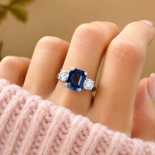Art Deco style sapphire and diamond three stone ring in platinum for sale in Leeds shown on hand