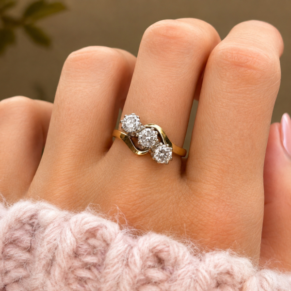 vintage three stone diamond bypass ring 1ct in 18ct yellow gold for sale in Leeds shown on a finger
