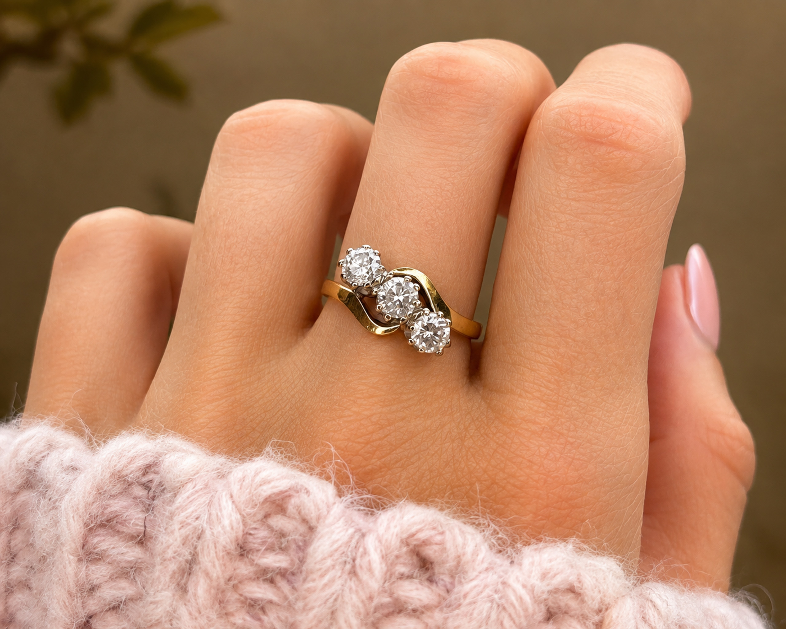 three stone bypass ring on hand