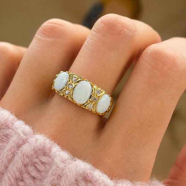 vintage three stone opal and diamond ring in 18ct yellow gold for sale in Leeds, shown on hand