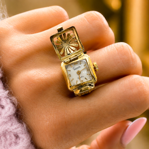 vintage gold metal ring watch circa 1950s/60s shown open on a model's hand