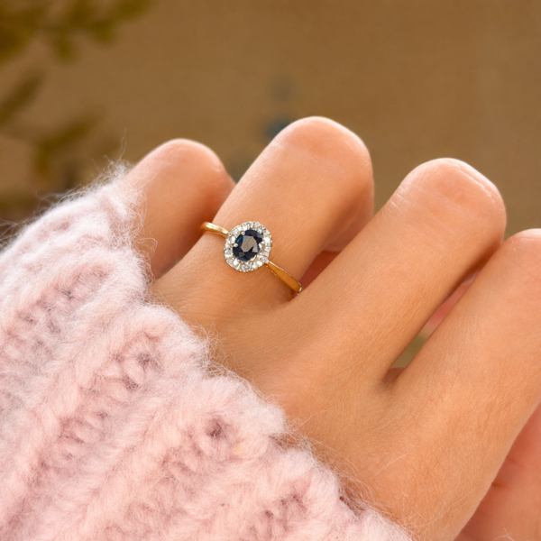 vintage sapphire and diamond cluster ring in 9ct yellow gold for sale in Leeds shown on a model's hand