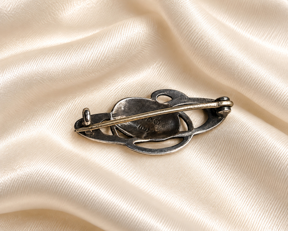 antique Charles Horner silver and enamel brooch for sale in Leeds on cream silk, showing the back of the brooch
