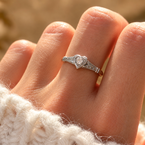 Art Deco diamond heart ring in 18ct yellow gold and platinum for sale in Leeds, shown on a woman's hand