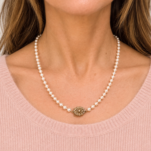 1940s cultured pearl necklace with 9ct yellow gold and pearl clasp shown on a model, for sale in Leeds