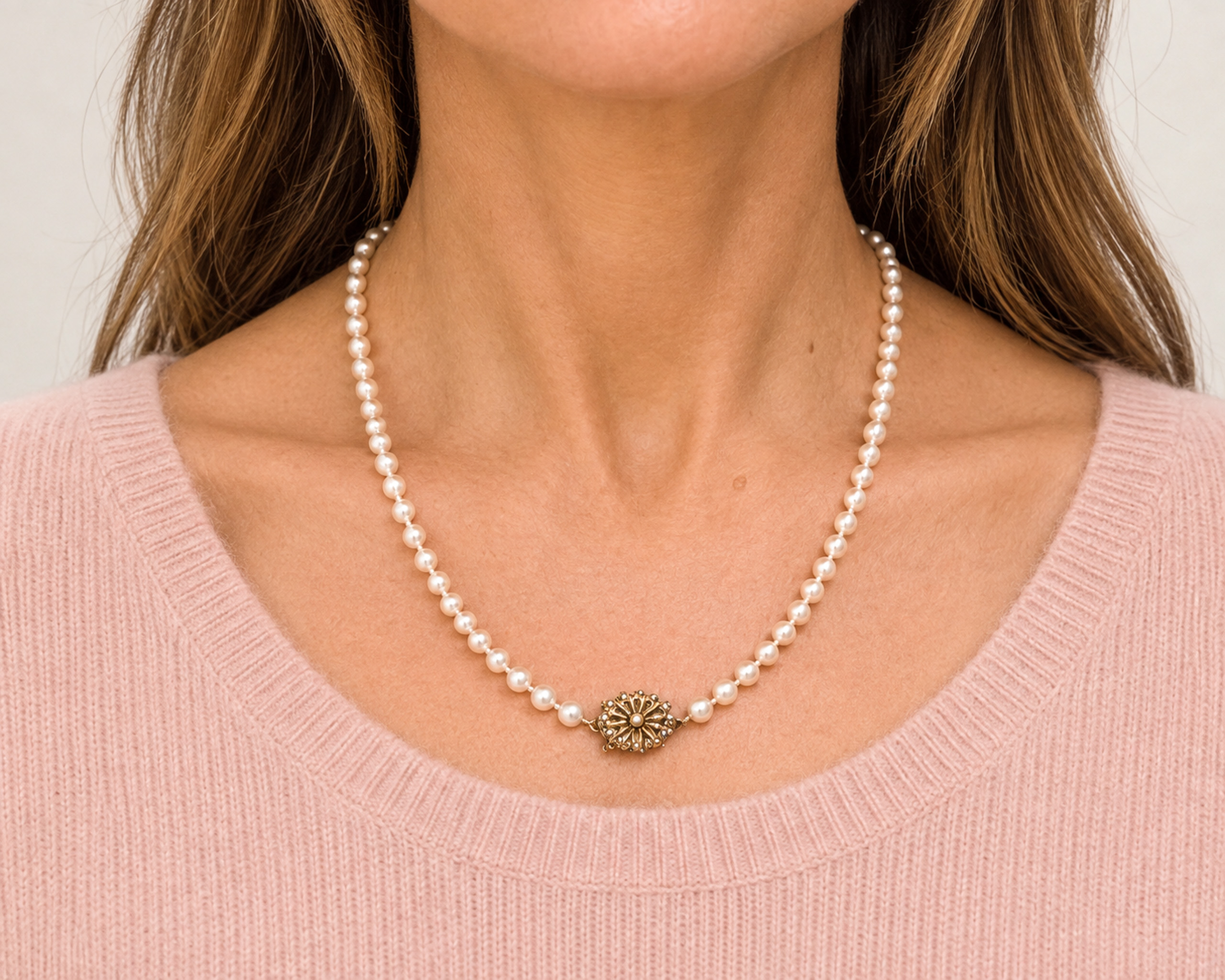 1940s cultured pearl necklace with 9ct yellow gold and pearl clasp shown on a model, for sale in Leeds