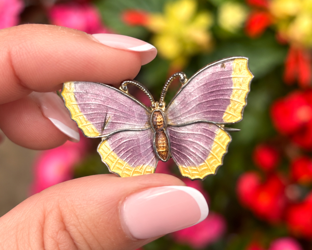 purple butterfly brooch in hand vintage silver and enamel butterfly brooch in hand