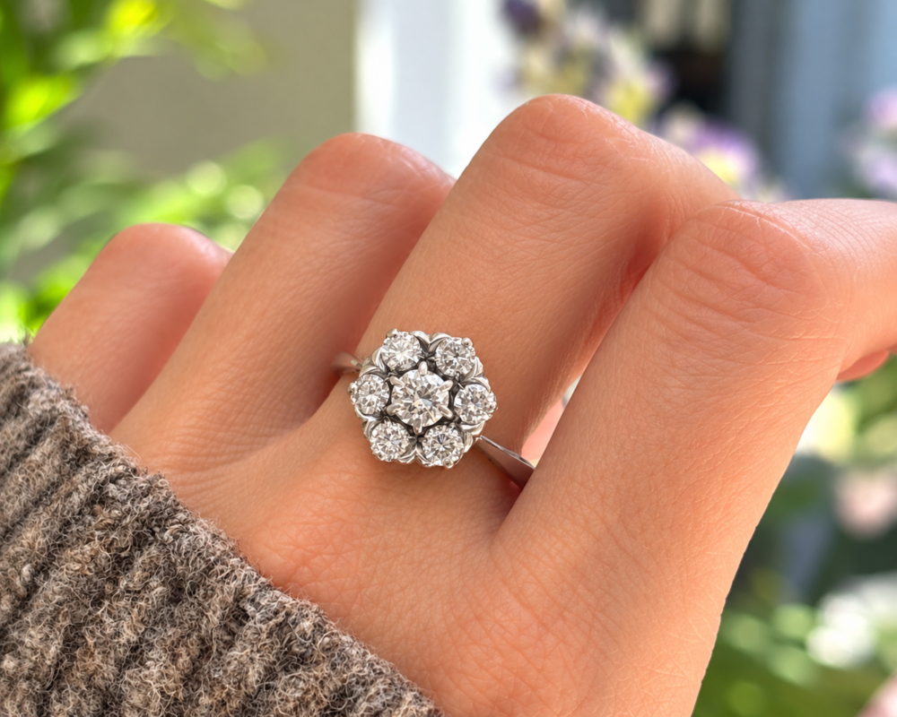 vintage flower cluster on hand vintage flower diamond cluster ring in 18ct white gold with 1.25ct for sale in Leeds, shown on a model's hand
