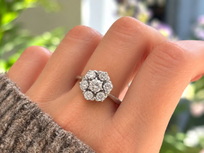 vintage flower diamond cluster ring in 18ct white gold with 1.25ct for sale in Leeds, shown on a model's hand