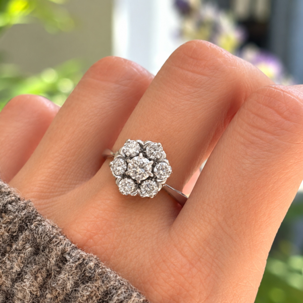 vintage flower diamond cluster ring in 18ct white gold with 1.25ct for sale in Leeds, shown on a model's hand