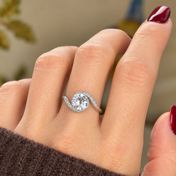 Antique 1930s diamond solitaire twist ring in platinum for sale in Leeds shown on a model's hand