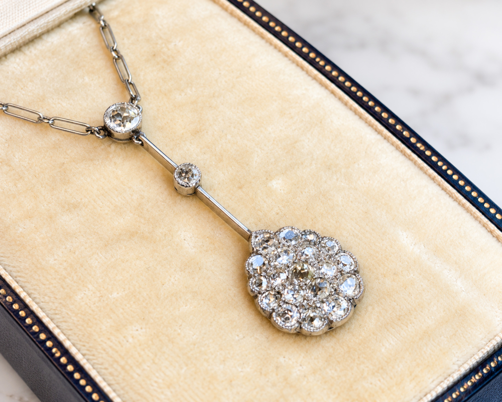 antique Edwardian old cut diamond necklace in platinum, displayed in an antique box