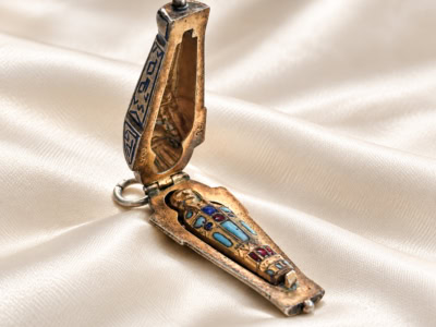 antique Egyptian Revival silver sarcophagus charm open to reveal mummy figure
