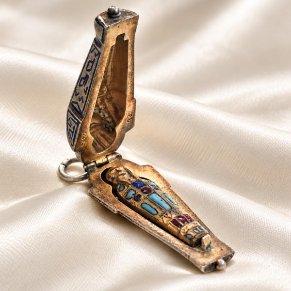 antique Egyptian Revival silver sarcophagus charm open to reveal mummy figure
