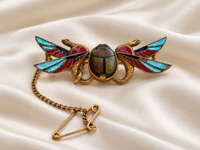 antique Egyptian Revival brooch in gilt and enamel for sale in Leeds
