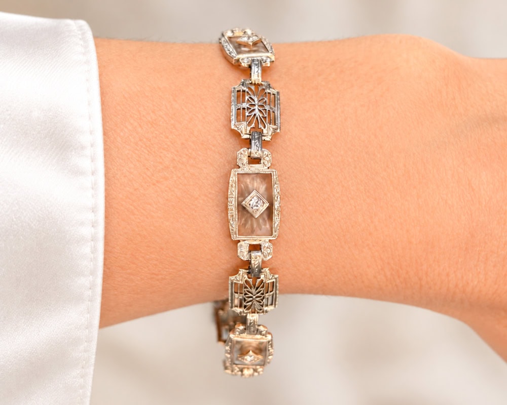 Art Deco Bracelet on wrist Art Deco 14ct white gold diamond panel bracelet with rock crystal panels and filigree detail, for sale in Leeds, shown on a woman's wrist