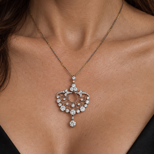 antique Edwardian era diamond pendant on a mixed metal chain for sale in Leeds, shown on a model