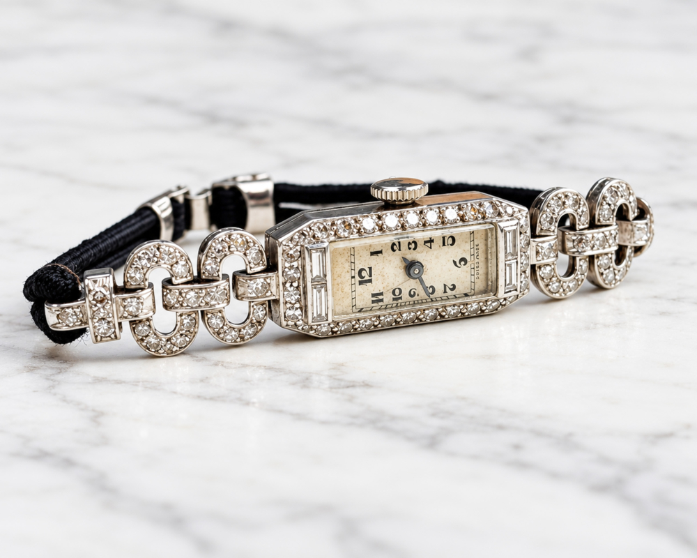 antique Art Deco diamond watch in 9ct white gold, displayed on marble