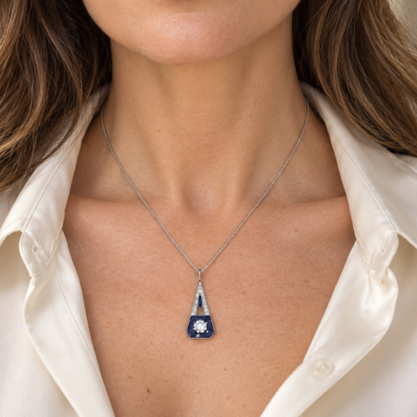 antique Art Deco sapphire and diamond pendant in 18ct white gold with French hallmarks. For sale in Leeds. shown on a model's neck