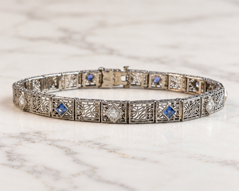 antique 1920s sapphire and diamond filigree bracelet, placed on marble