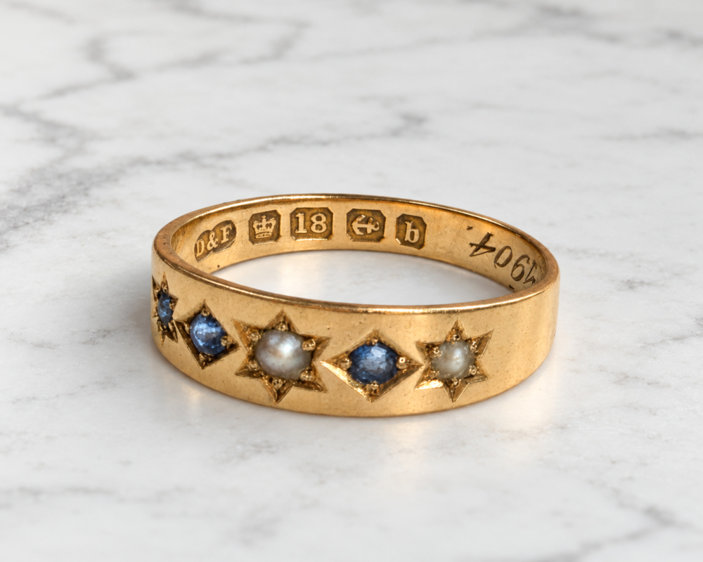 antique Edwardian era sapphire and seed pearl ring in 18ct gold and dated 1904, showing hallmark