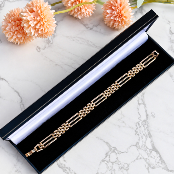 antique Edwardian 9ct gold gate bracelet displayed in a black bracelet box