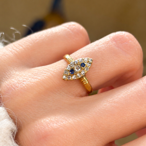 antique Victorian sapphire and old cut diamond navette ring in gold for sale in Leeds, on a model's hand