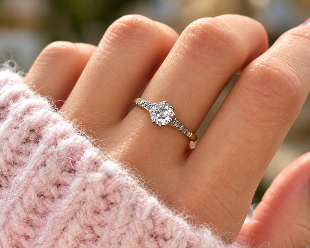 antique Art Deco diamond solitaire with diamond shoulders in 18ct yellow gold and platinum 0.7ct for sale in Leeds, shown on a model's hand