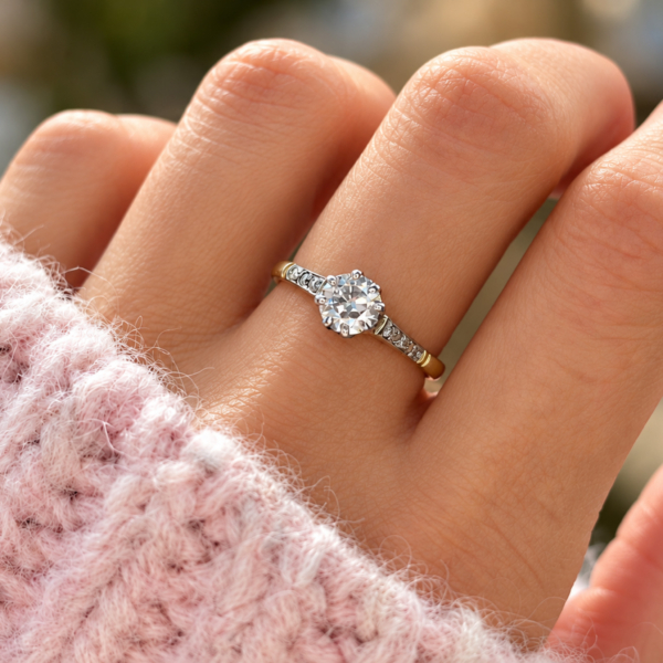 antique Art Deco diamond solitaire with diamond shoulders in 18ct yellow gold and platinum 0.7ct for sale in Leeds, shown on a model's hand