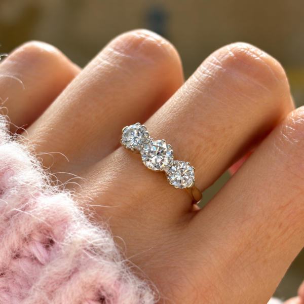 Vintage diamond three stone ring 1.35ct in 18ct yellow gold for sale in Leeds on a model's hand
