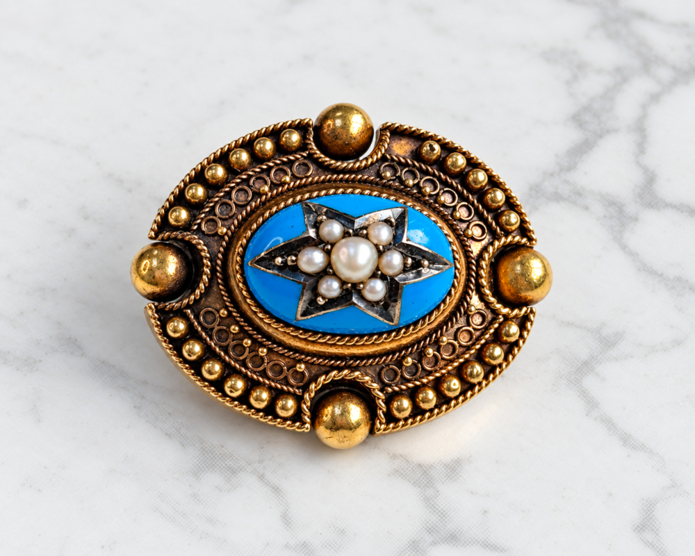antique Victorian Etruscan Revival gold and enamel brooch with seed pearls in a star setting. Displayed on marble