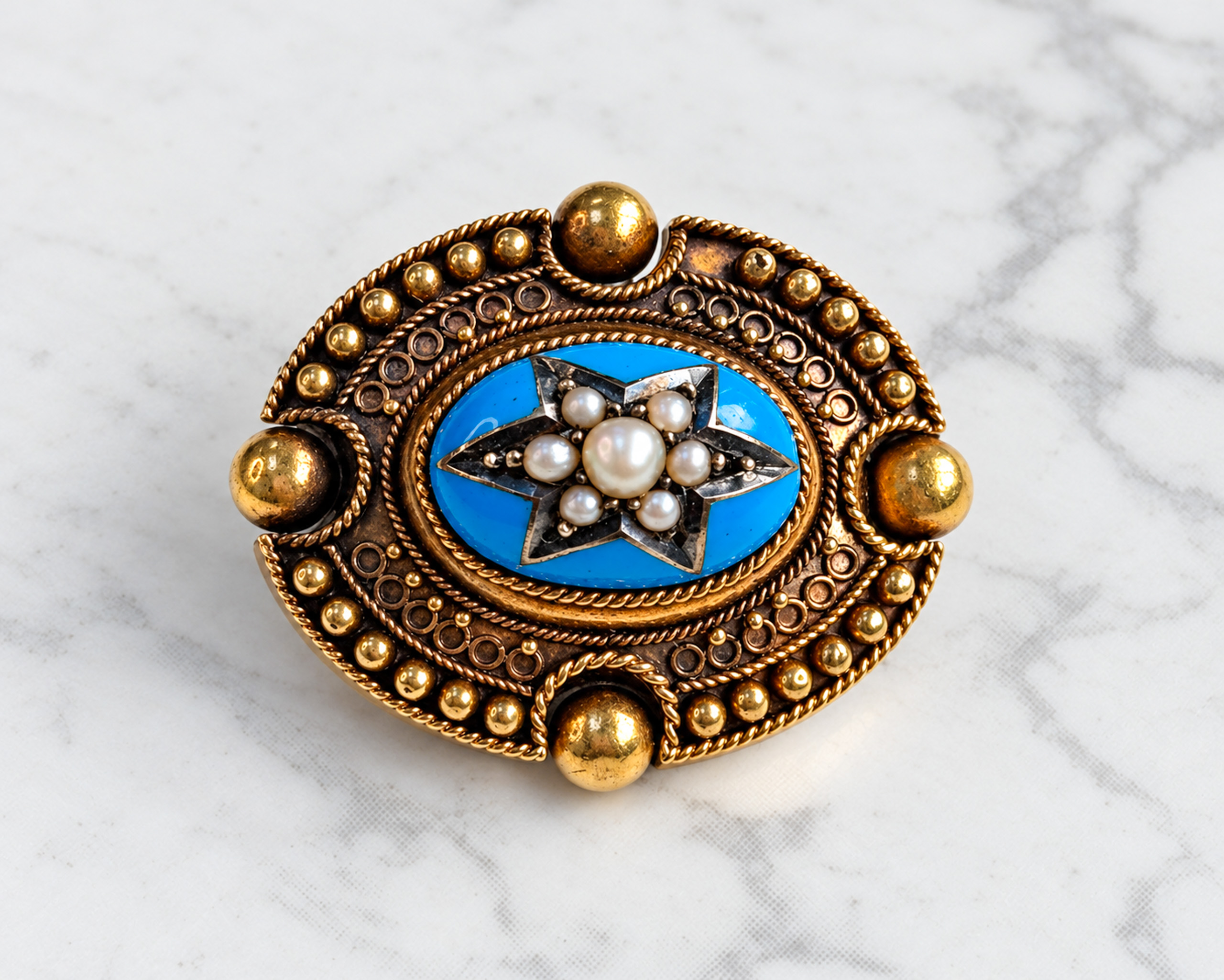 Victorian Etruscan Revival enamel and seed pearl brooch set in gold.