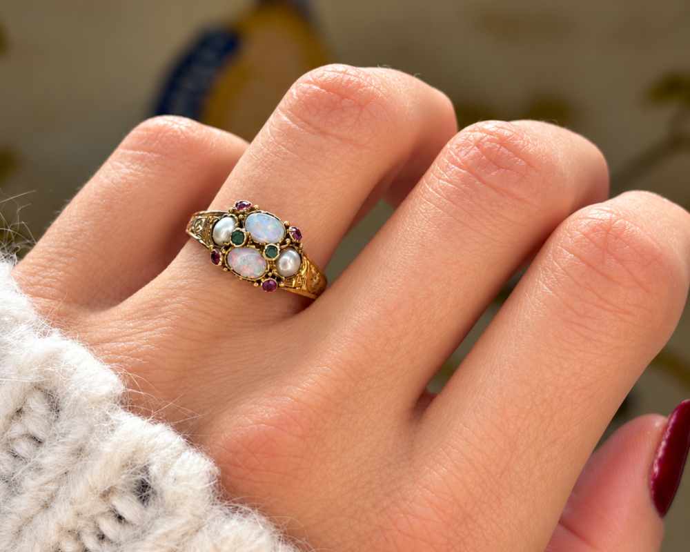 antique Victorian opal, amethyst, emerald and pearl ring in 15ct gold dated 1864 for sale in Leeds, shown on a model's finger