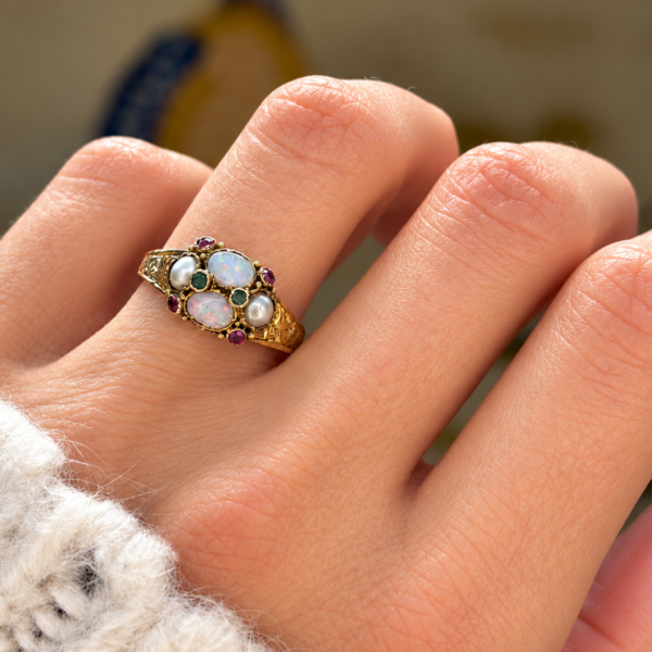 antique Victorian opal, amethyst, emerald and pearl ring in 15ct gold dated 1864 for sale in Leeds, shown on a model's finger