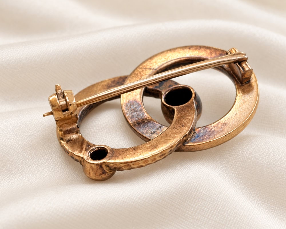 antique Victorian serpent brooch in gold with emerald and old cut diamond, showing the reverse of the brooch