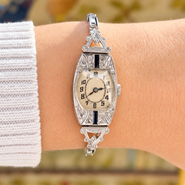 antique Art Deco diamond cocktail watch set with sapphires in platinum with a 9ct white gold strap. For sale in Leeds, shown on a lady's wrist