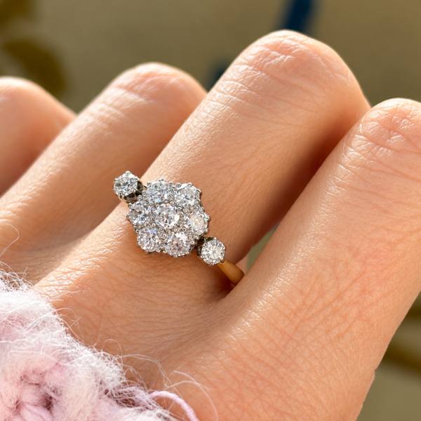 antique diamond daisy cluster ring 1ct in 18ct yellow gold and platinum for sale in Leeds, shown on a model's hand
