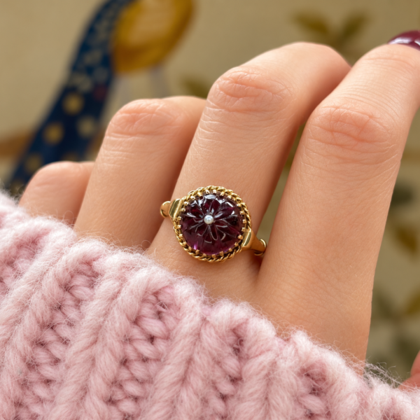 antique Victorian garnet and seed pearl ring in 15ct gold, on a hand