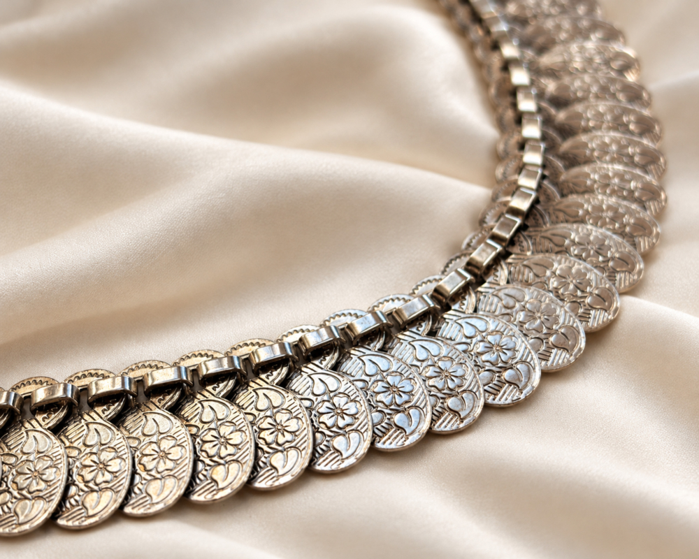 vintage silver coin necklace close up of floral engraving