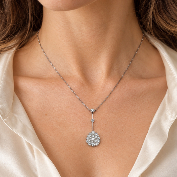 A model wearing an antique Edwardian old cut diamond necklace in platinum,