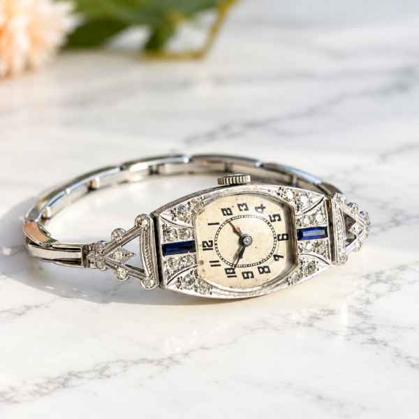 antique Art Deco diamond cocktail watch set with sapphires in platinum with a 9ct white gold strap. For sale in Leeds