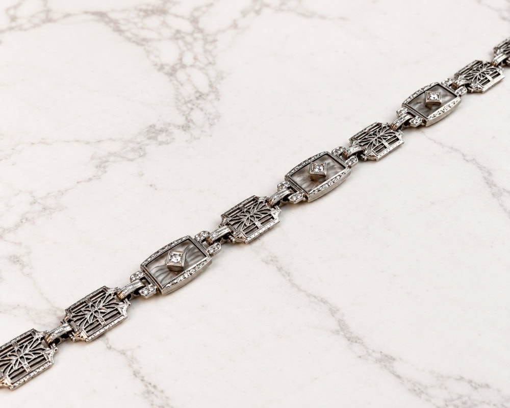 Art Deco 14ct white gold diamond panel bracelet with rock crystal panels and filigree detail, for sale in Leeds