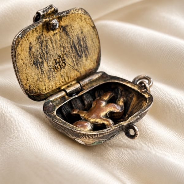 antique Egyptian Revival Moses basket charm in 800 silver for sale in Leeds, open to reveal baby Moses