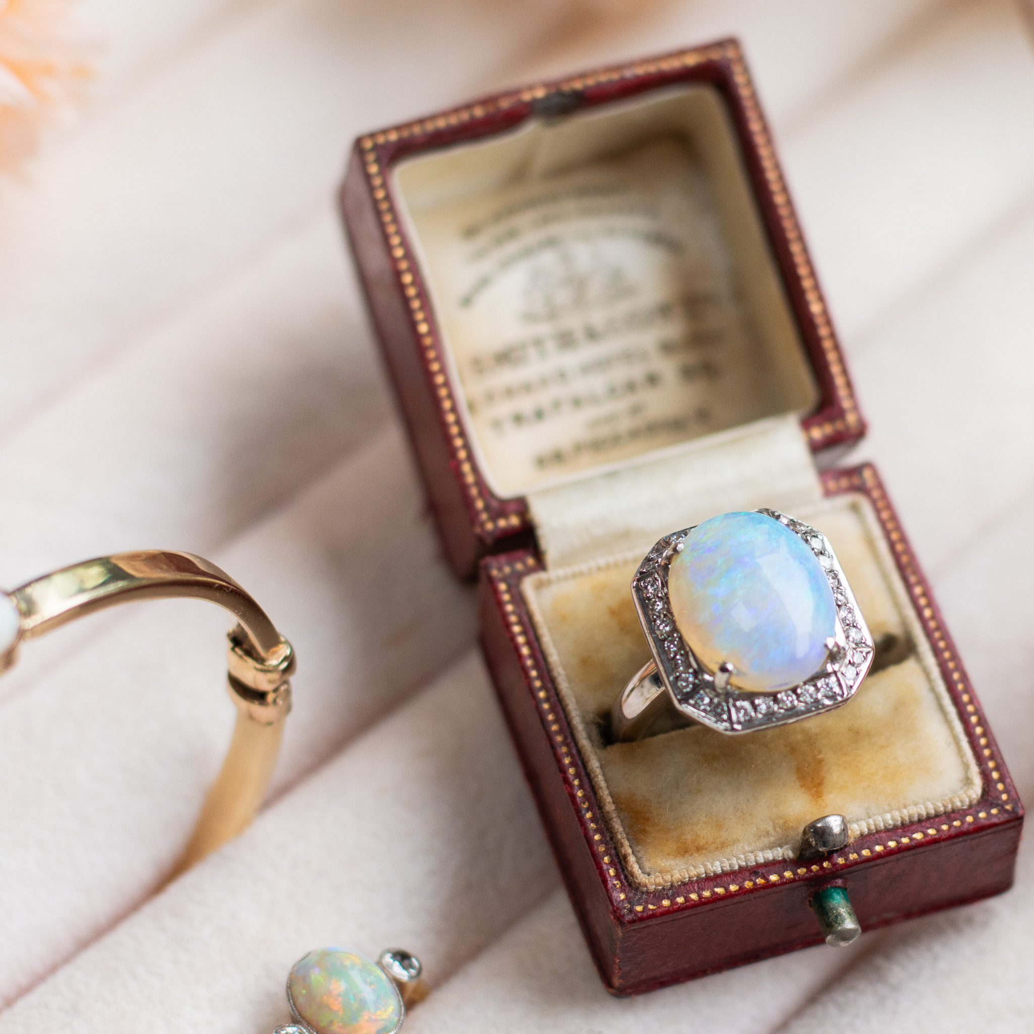 an antique style opal ring in a ring box