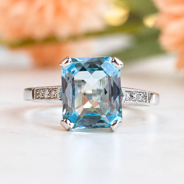 vintage style blue topaz and diamond ring in 9ct white gold